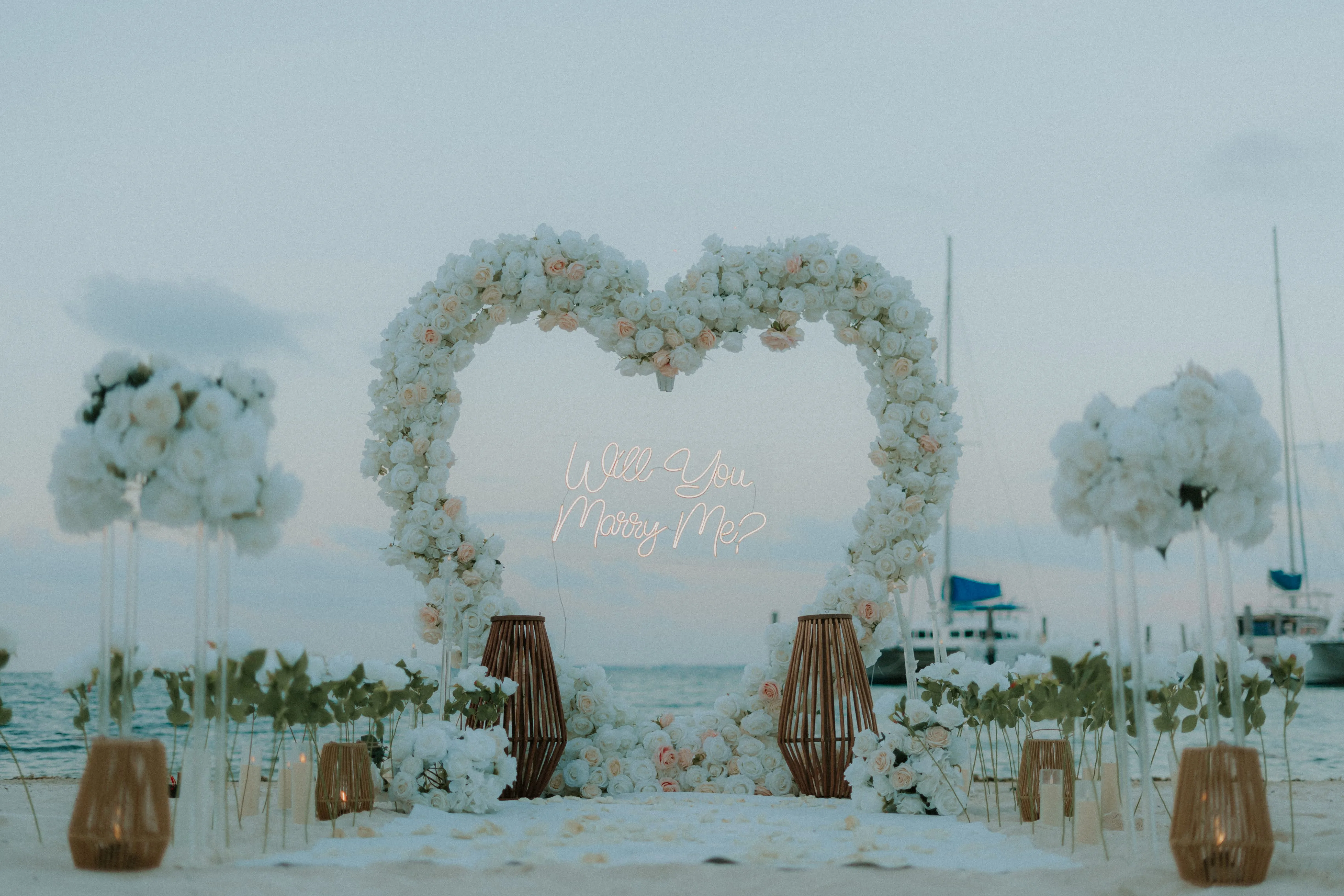 Romantic beach engagement with arch