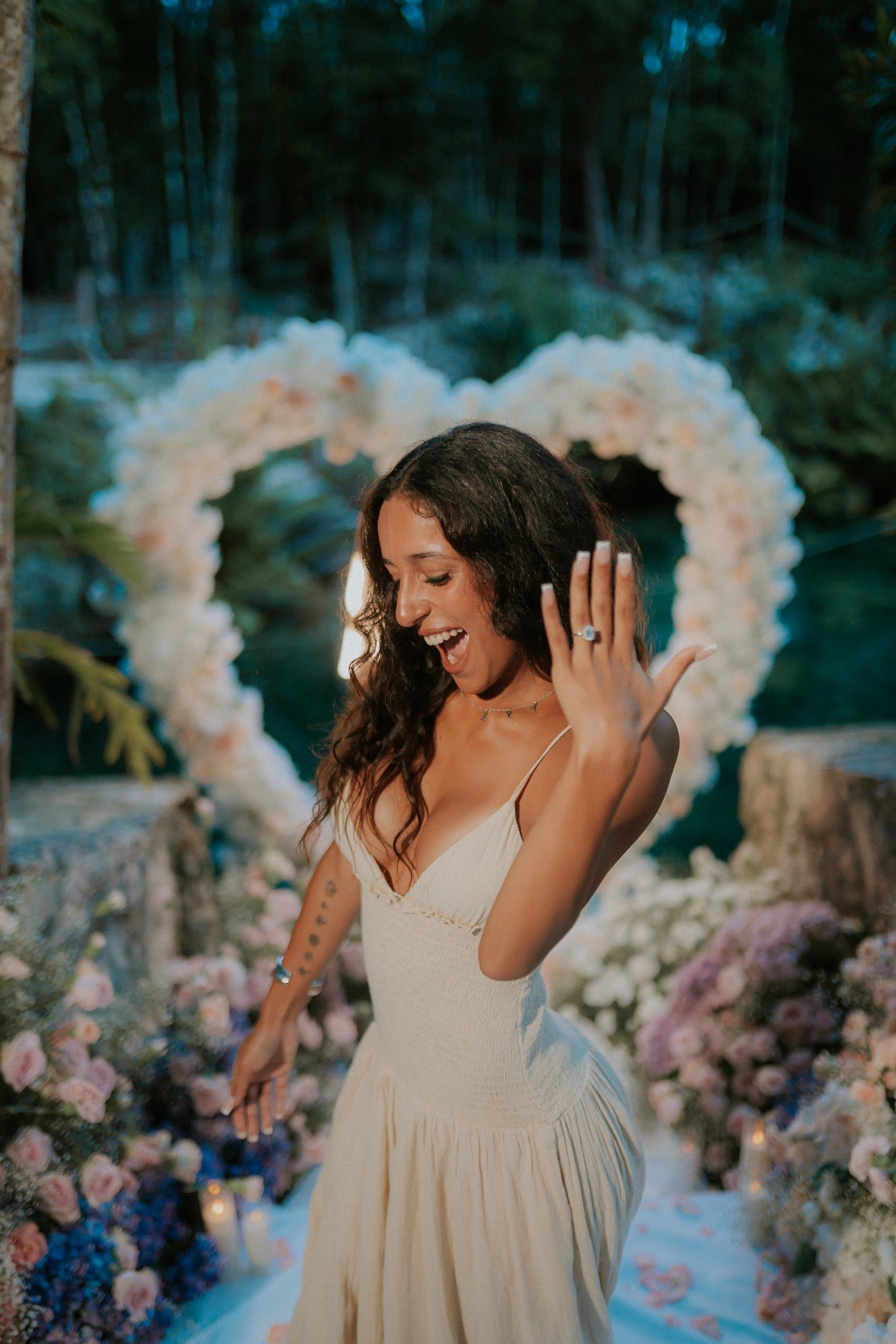 Dreamy cenote proposal moment in Tulum with the couple's reflection shimmering in the calm, azure waters of a jungle lagoon.