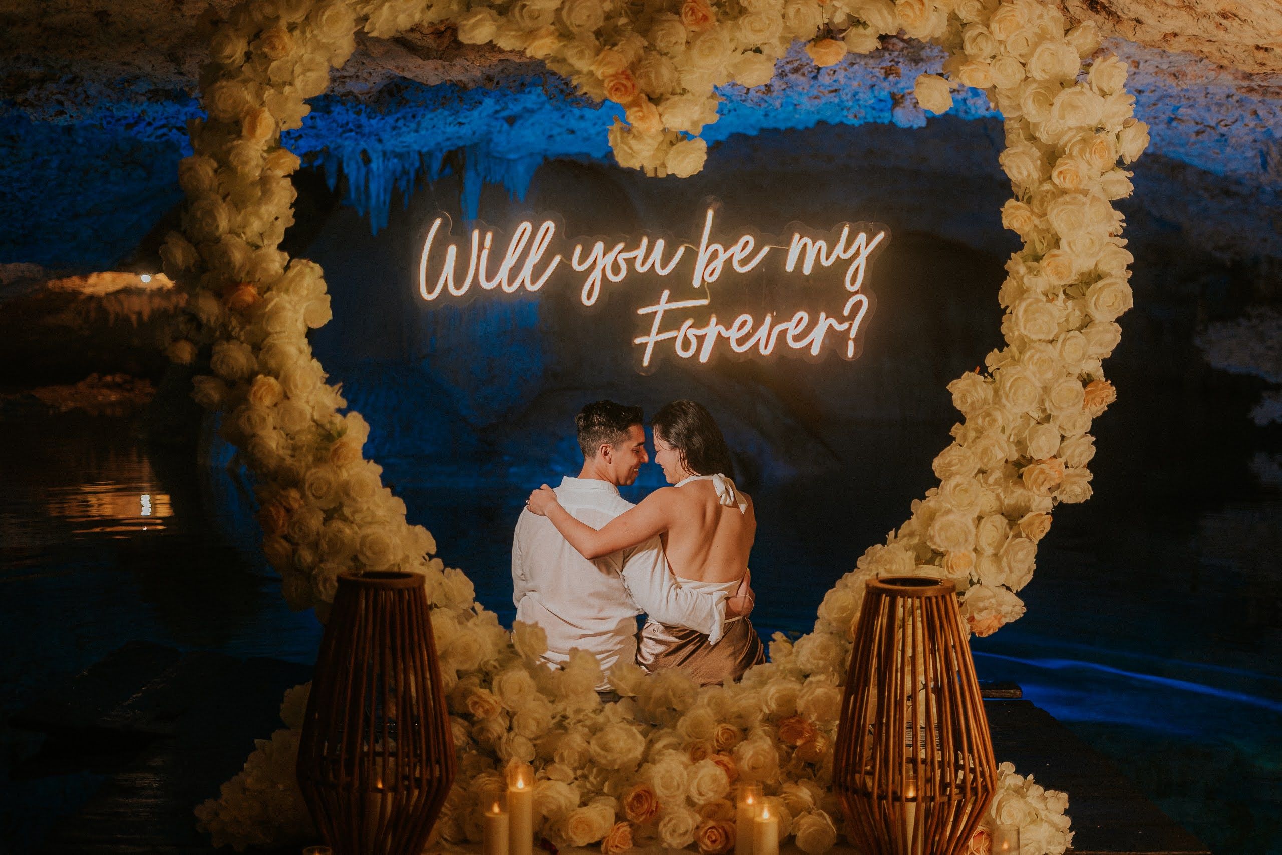 Intimate marriage proposal at a private cenote in Tulum featuring crystal-clear turquoise waters and ancient rock formations.