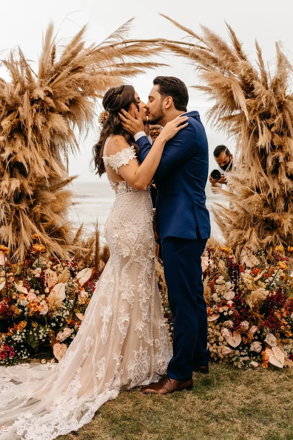 Couple kissing during a tropical elopement ceremony