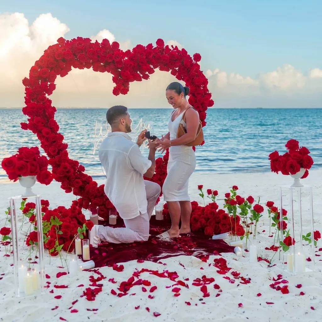 A proposal happening on a private Caribbean beach with a rose heart arch and clear ocean behind it