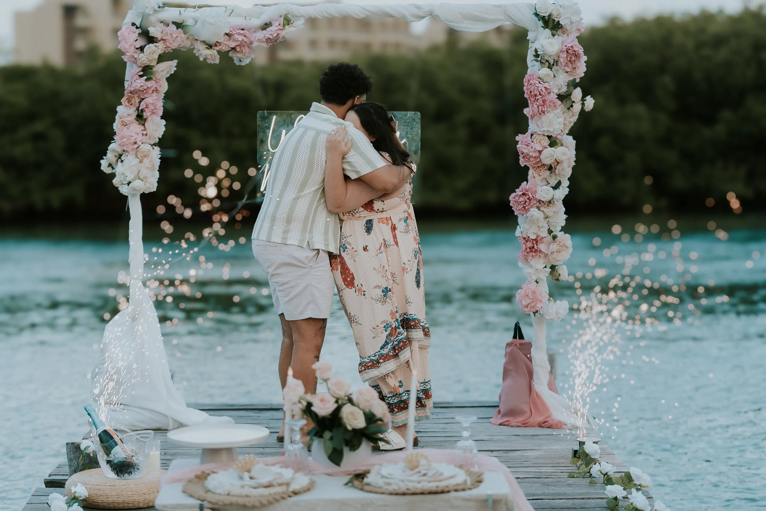 Couple celebrating a private waterside marriage proposal in Riviera Maya