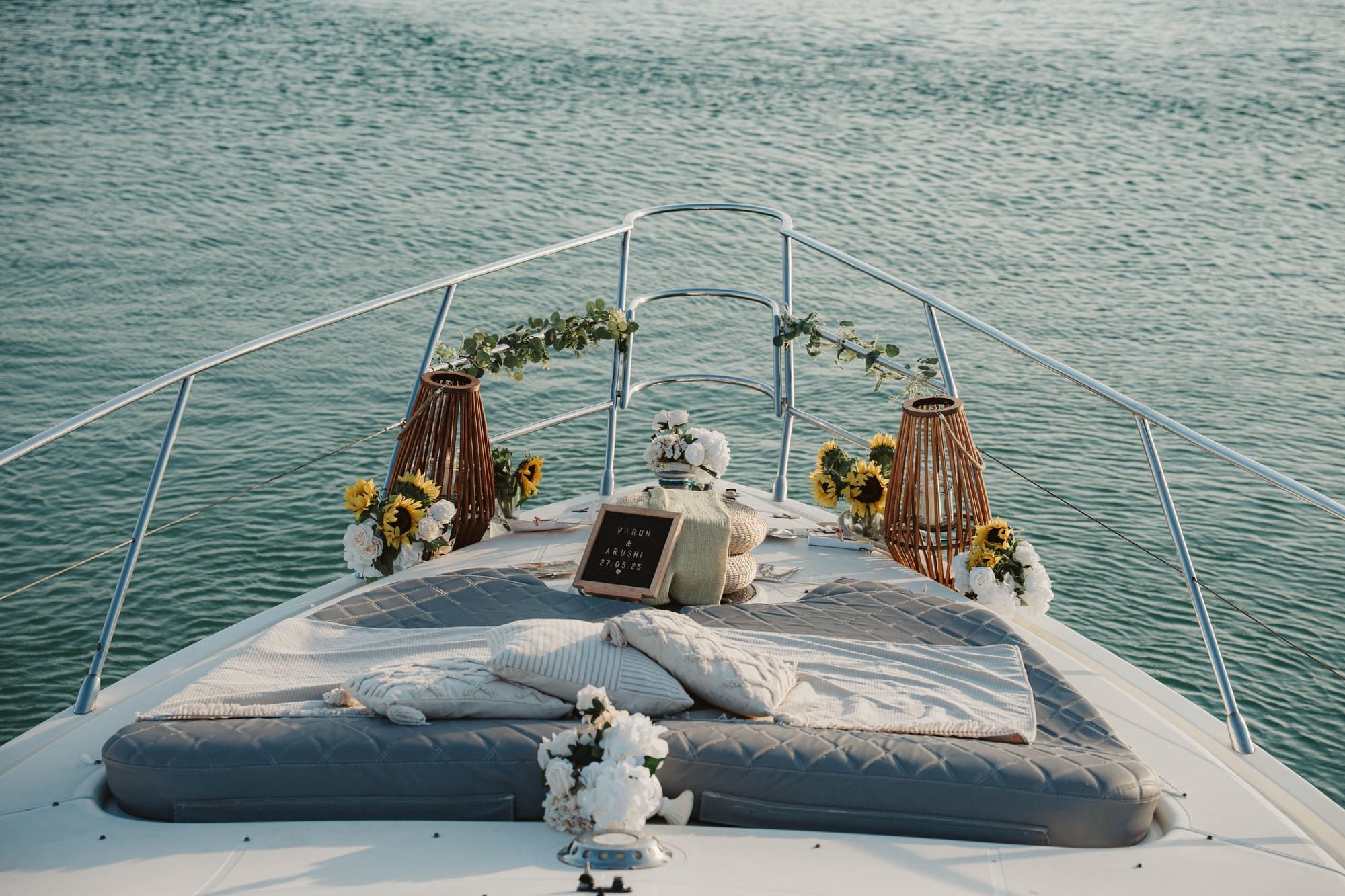 Romantic rooftop proposal setup in Cancun at sunset with string lights, a bottle of champagne, and panoramic views of the Nichupté Lagoon.
