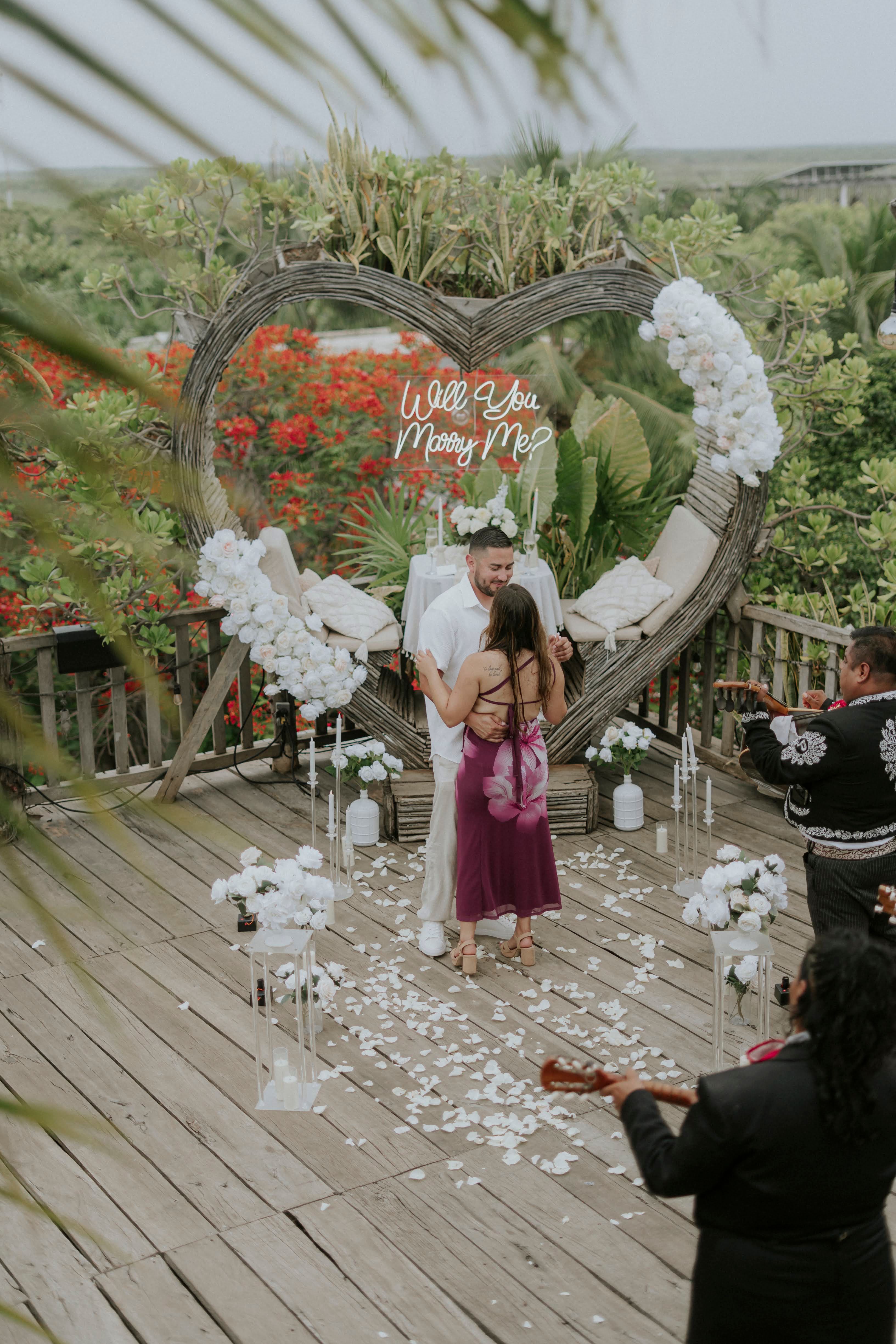 Breathtaking aerial view of a rooftop proposal setup in Playa del Carmen, overlooking the city and the ocean.