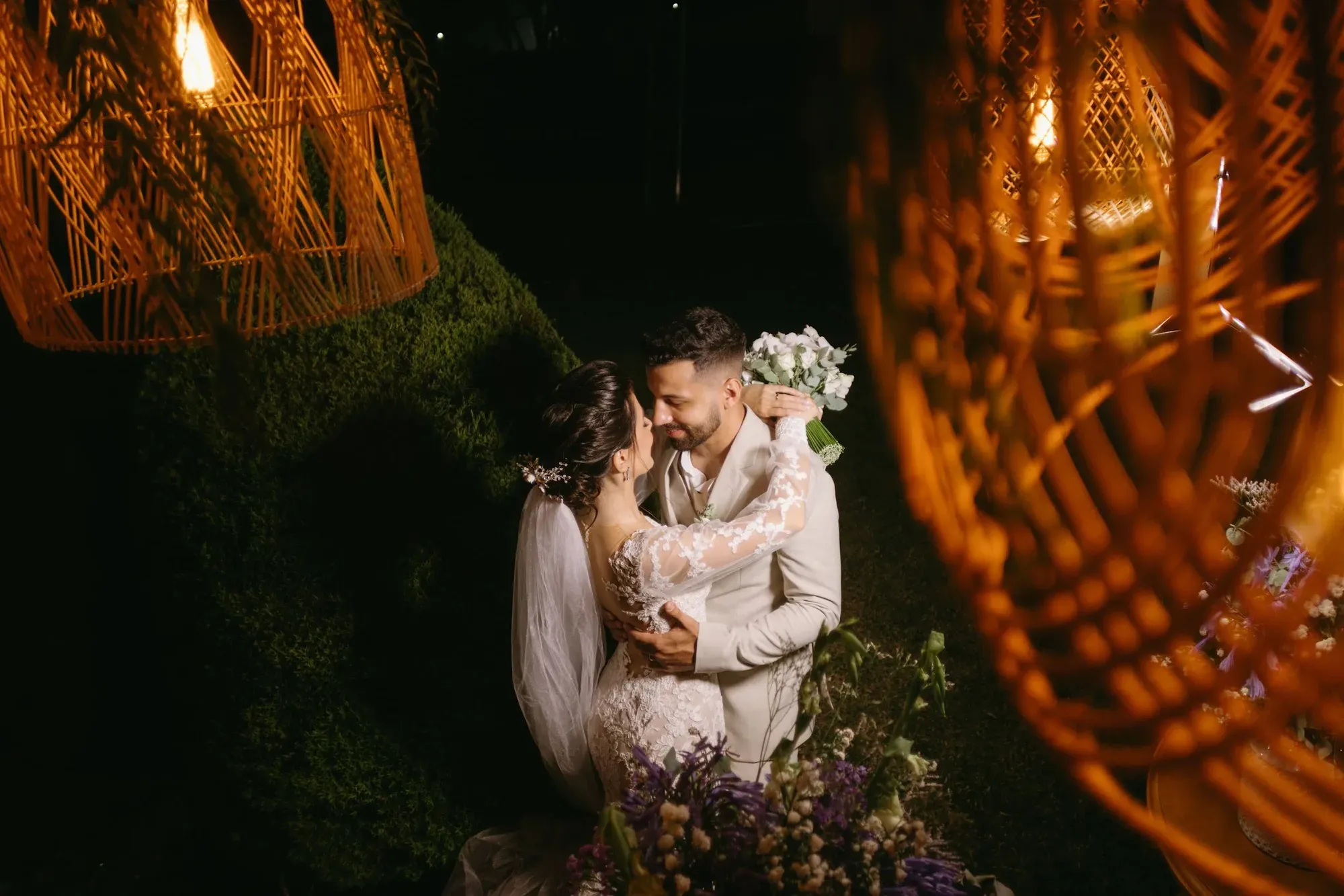 Nighttime portrait of a couple among tropical greenery