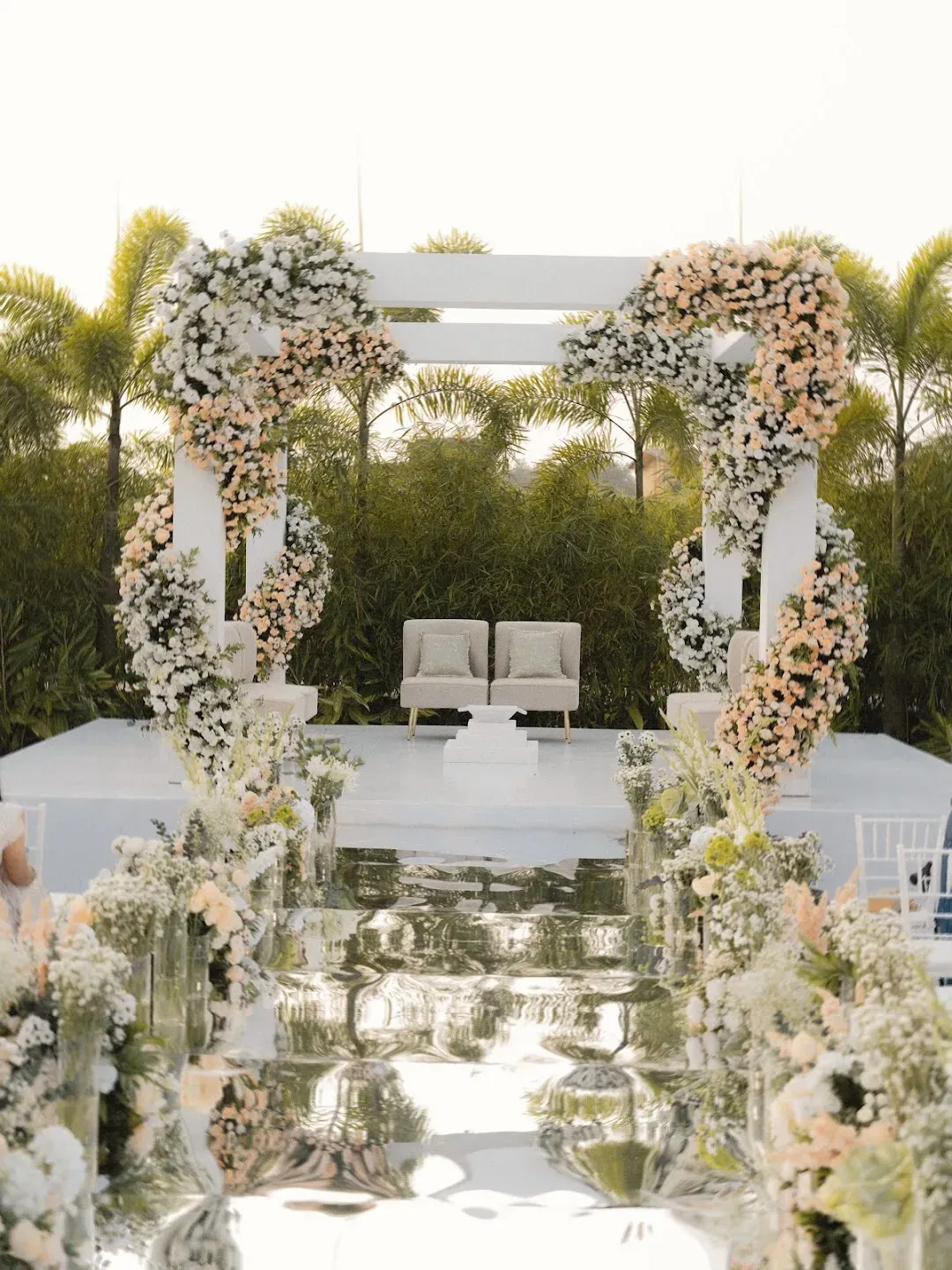 White floral ceremony platform with lounge seating